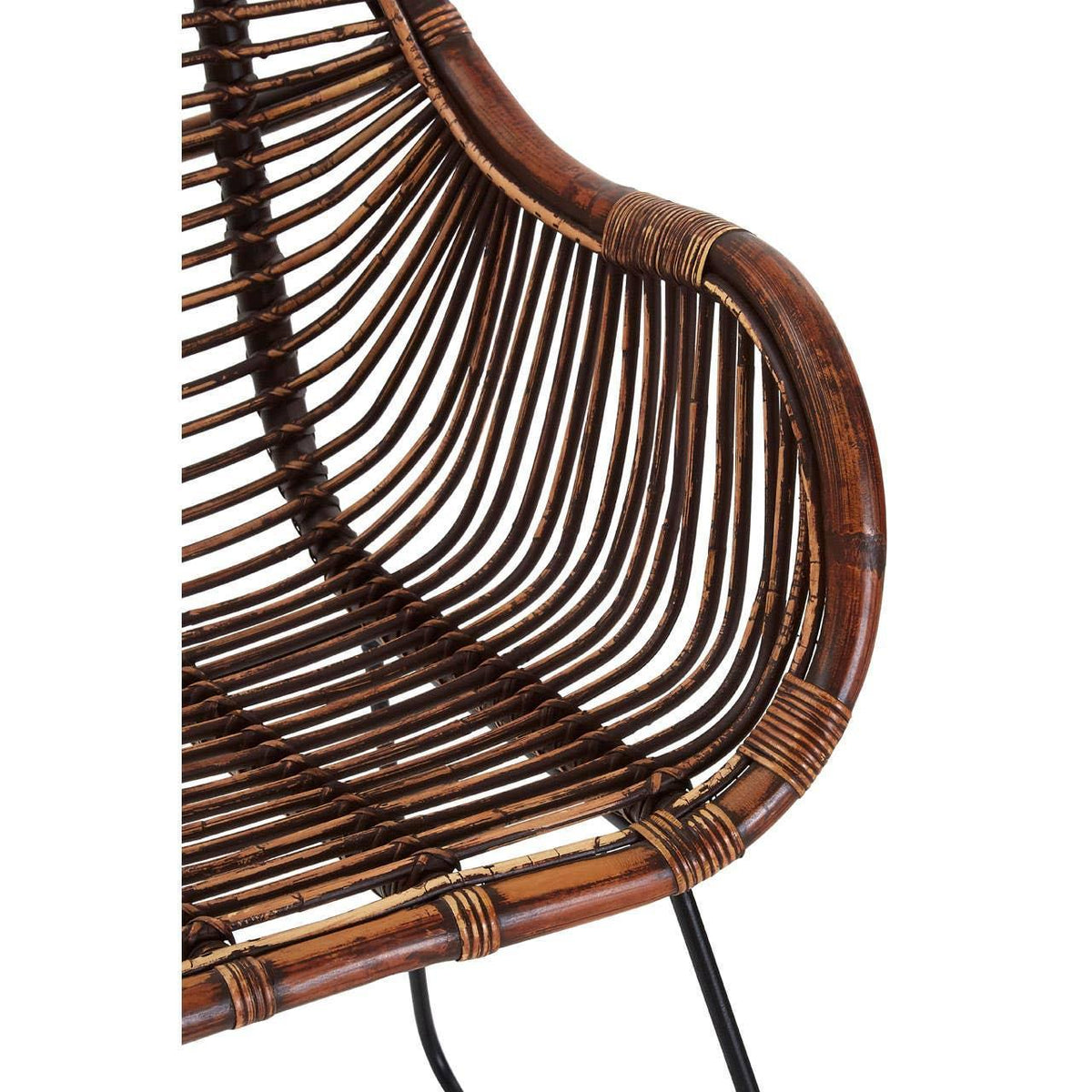 Close-up of curved brown rattan chair arm and seat with black metal legs