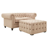 Beige linen stool featuring button tufting and a square shape, complemented by rounded edges and short wooden legs. The design includes a matching armchair with a similar tufted style, creating a cohesive look for home decor