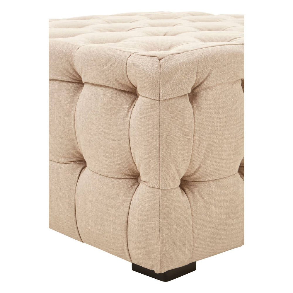 Beige linen stool featuring a button-tufted design with a square top and rounded edges, resting on a small black base