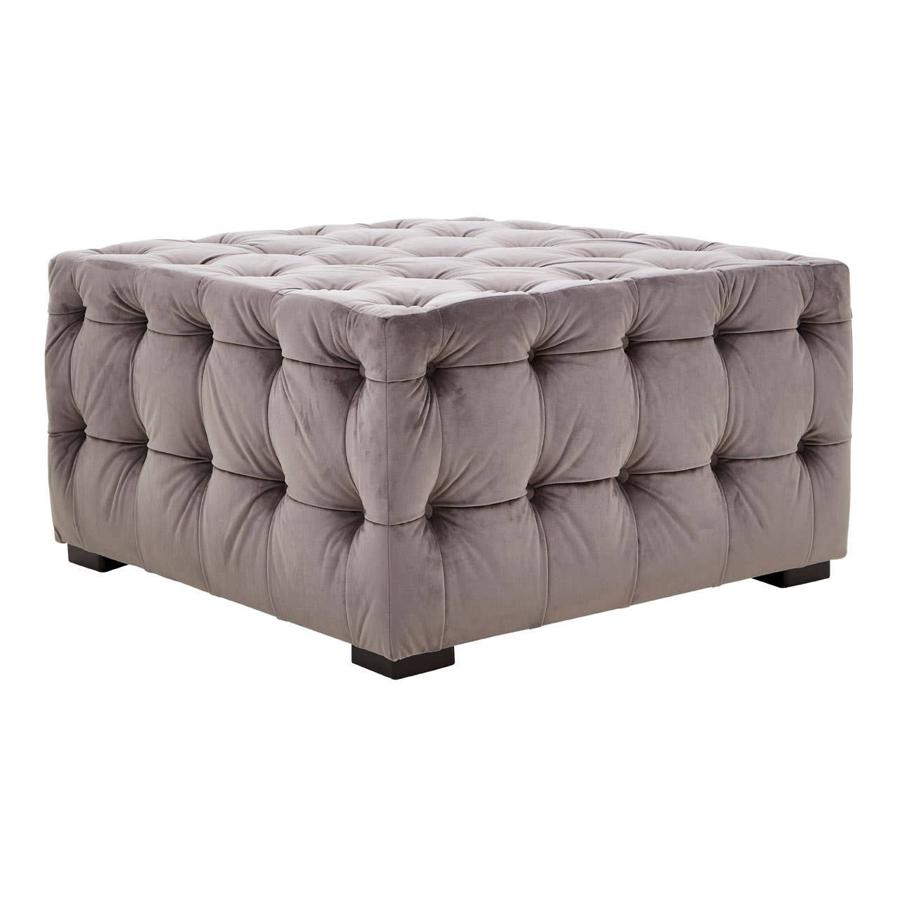 Square stool upholstered in soft grey velvet with button tufting, featuring a plush top and sturdy black legs