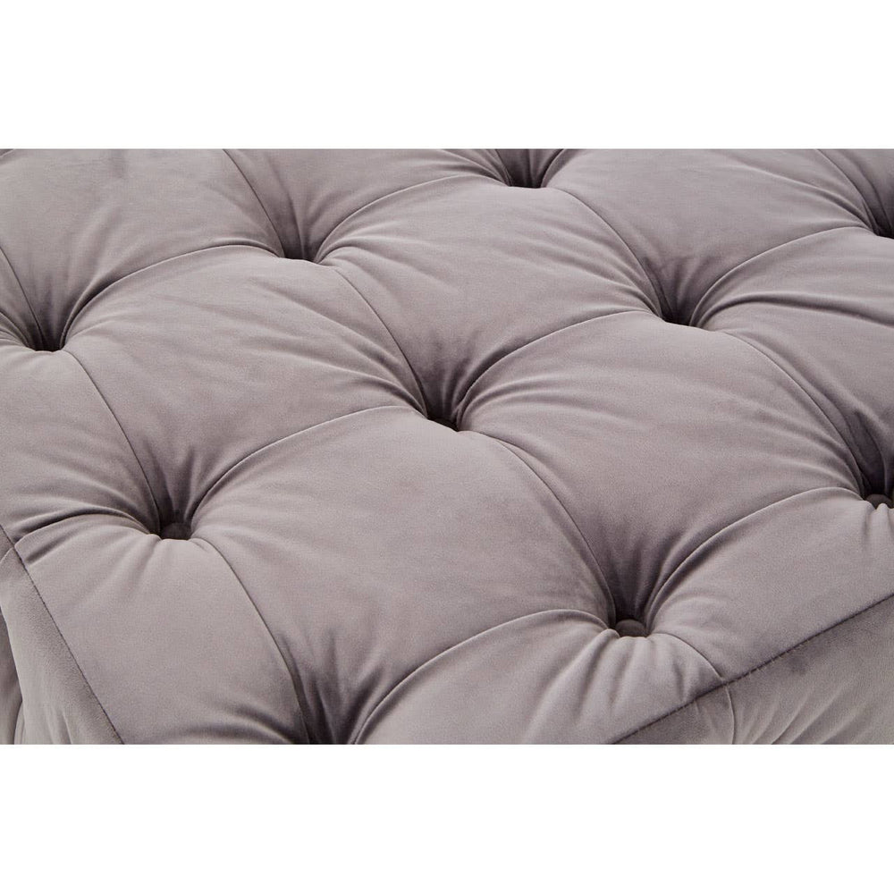 Soft grey velvet fabric with a button-tufted design, featuring deep indentations and a plush texture, creating a luxurious and inviting appearance