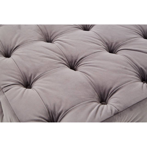 Soft grey velvet fabric with a button-tufted design, featuring deep indentations and a plush texture, creating a luxurious and inviting appearance