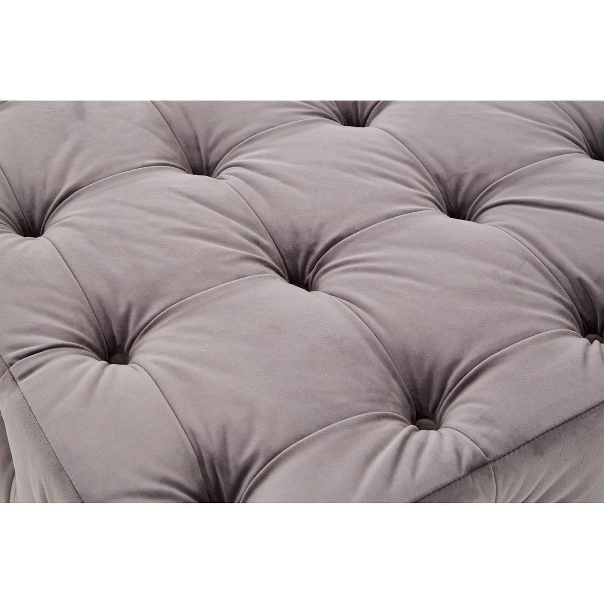 Soft grey velvet fabric with a button-tufted design, featuring deep indentations and a plush texture, creating a luxurious and inviting appearance