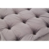 Soft grey velvet fabric with a button-tufted design, featuring deep indentations and a plush texture, creating a luxurious and inviting appearance