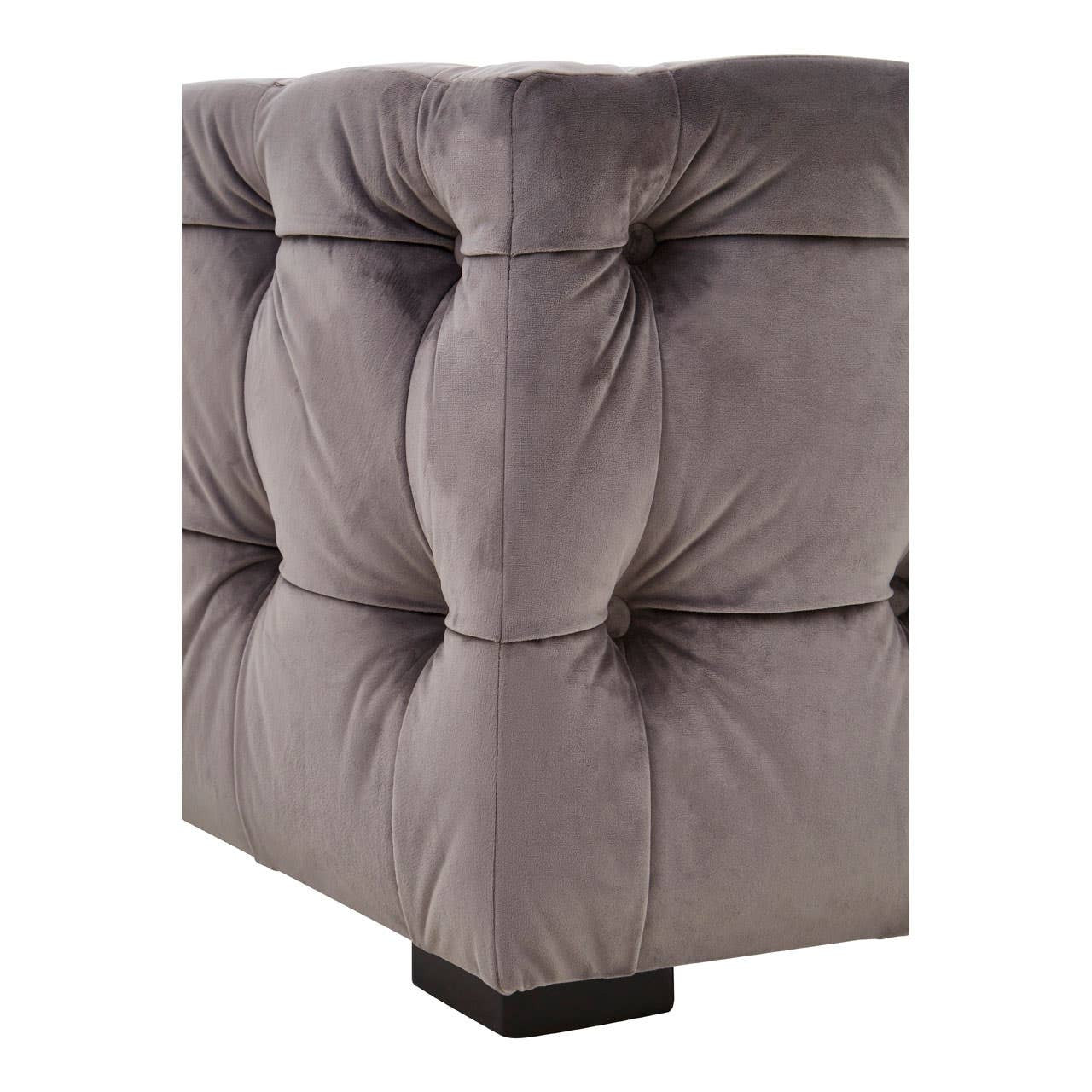 Grey velvet stool with a button-tufted design, featuring a square shape and a sturdy base. The fabric has a soft texture, and the tufting creates a plush, elegant appearance