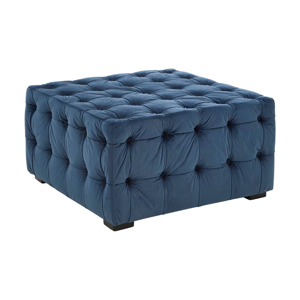 Square stool upholstered in midnight blue velvet, featuring a tufted design with buttons and a sturdy base. The stool has a plush appearance and is suitable for use as extra seating or a footrest