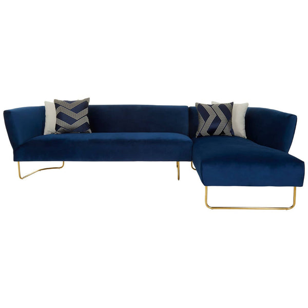 Dark blue velvet corner sofa with five seating areas, featuring a sleek design and gold metal legs. Two decorative pillows with abstract patterns are placed on the backrest. The chaise section extends on one side, providing additional lounging space