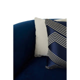 Dark blue velvet corner sofa with a plush texture, featuring a decorative pillow with a geometric pattern in shades of gray and navy. The sofa's armrest is visible, showcasing its modern design and comfortable seating