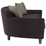 Three-seat sofa upholstered in black dimity fabric, featuring a sleek, modern design with rounded edges. The sofa has tapered wooden legs and comes with two decorative cushions in a contrasting pattern. The overall look is stylish and contemporary, suitable for various living spaces