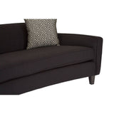 Three-seat sofa upholstered in black dimity fabric, featuring a sleek, curved design and wooden legs. A decorative cushion with a subtle pattern rests on one side, enhancing the modern aesthetic