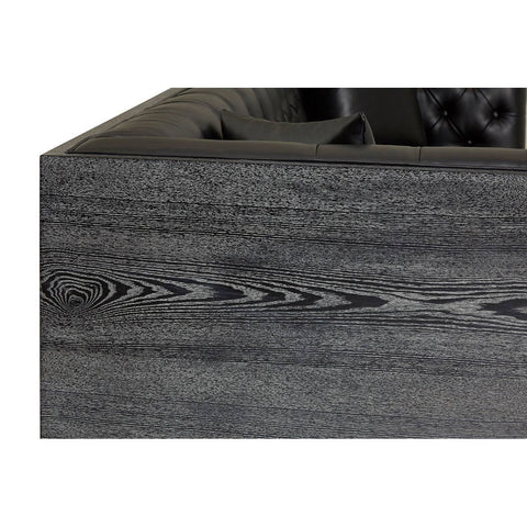 Close-up view of the dark wood grain texture on the edge of a furniture piece, showcasing a smooth finish and natural patterns