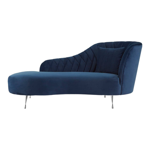 A dark blue velvet chaise longue with a sleek, modern design, featuring a curved backrest and a low profile. The chaise is supported by slender metal legs, adding a touch of elegance to its overall appearance. The fabric has a soft texture, enhancing its luxurious look