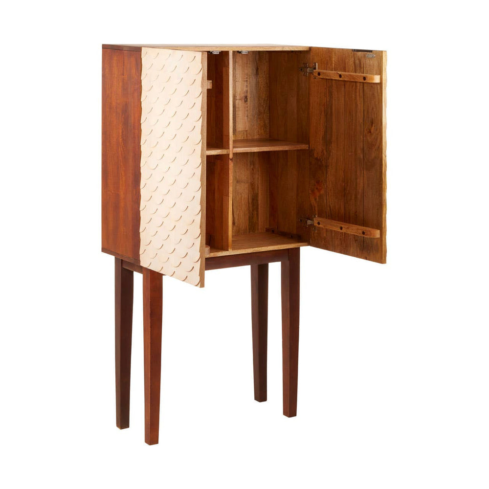 Coastal carved mango wood cabinet with two doors, featuring a natural wood finish and a textured design on the front. The cabinet stands on four slender legs and has an open interior with two shelves for storage