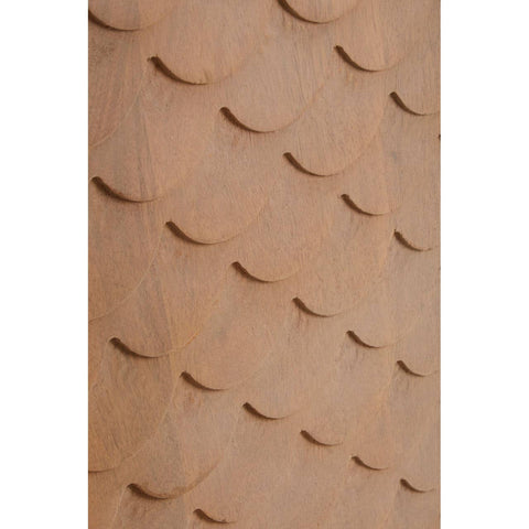Close-up view of the textured surface of a coastal carved mango wood cabinet, featuring a series of rounded, overlapping shapes that create a wave-like pattern in a warm, natural wood finish