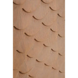 Close-up view of the textured surface of a coastal carved mango wood cabinet, featuring a series of rounded, overlapping shapes that create a wave-like pattern in a warm, natural wood finish