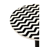 Round side table featuring a mosaic design with a zigzag pattern in black and white, crafted from acacia wood. The table has a sleek pedestal base, emphasizing its modern aesthetic