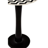Round acacia wood pedestal side table featuring a mosaic design on the top surface, supported by a sleek black pedestal base. The table has a smooth, circular top with a decorative pattern and a sturdy, minimalist stand
