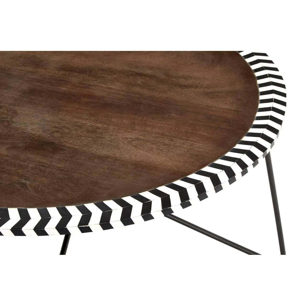 Round wooden coffee table with black and white chevron inlay on metal legs