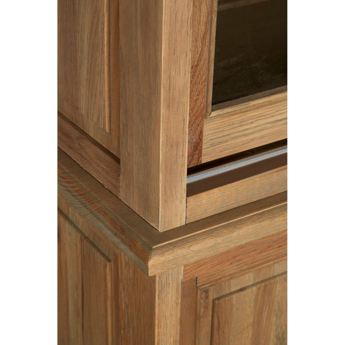 Tall cabinet made of oak wood featuring a washed grey finish, showcasing clean lines and a modern design. The cabinet has a textured surface with visible wood grain and a sleek, minimalist profile