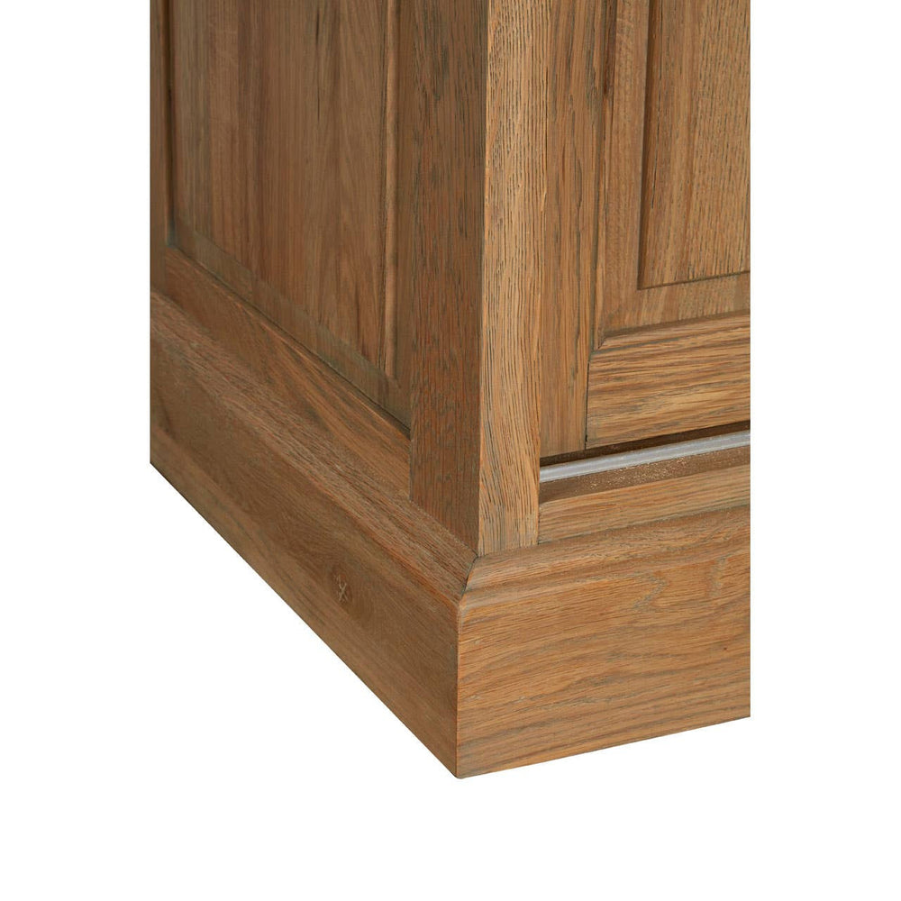 Close-up view of the base of the Lyon Oak Wood Tall Cabinet, showcasing the washed grey finish and detailed wood grain texture. The cabinet features a sturdy, rectangular design with clean lines and a subtle paneling effect on the sides