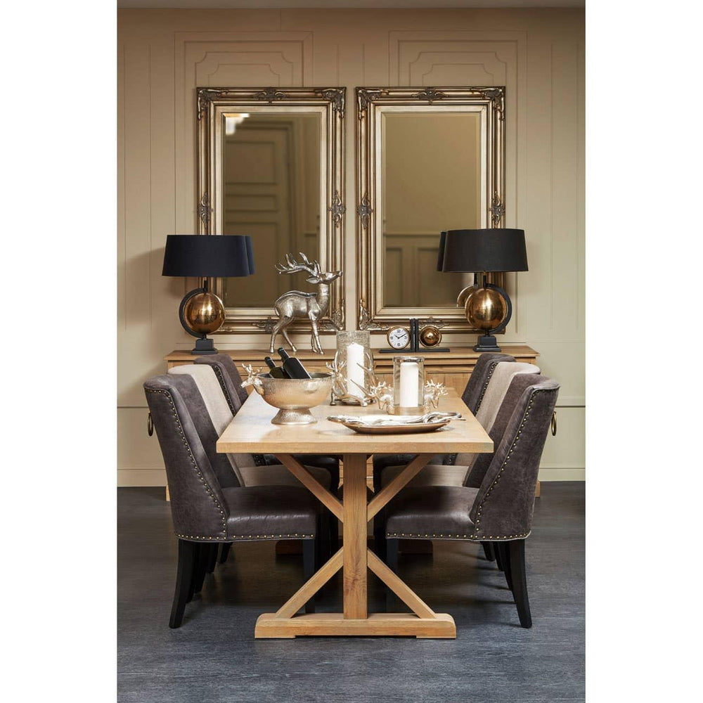 Oak dining table with grey upholstered chairs, gold accents and decorative mirrors