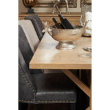 Oak dining table with studded velvet chairs and silver wine cooler with stag head handles