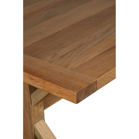 Closeup of solid oak dining table corner showing natural wood grain finish