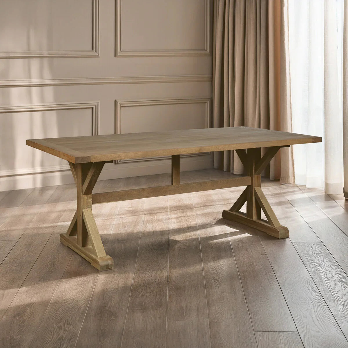 Wooden dining table with trestle legs on oak flooring in a bright room