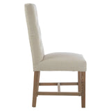 Side view of beige upholstered dining chair with wooden legs and cushioned seat