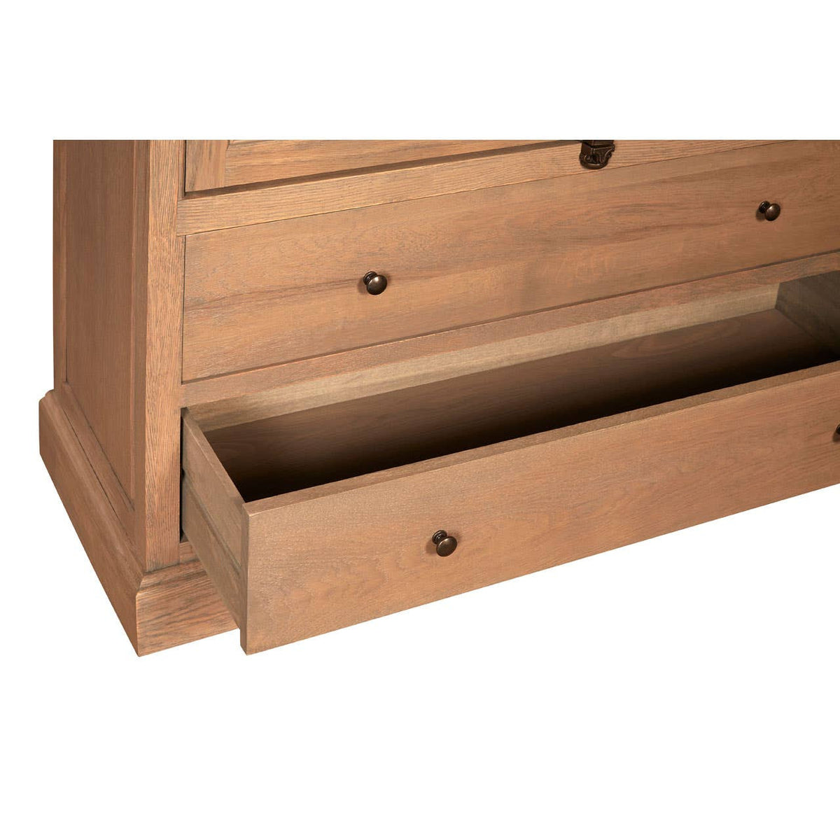 Tall cabinet featuring a washed grey finish, made from oak wood. The image shows a close-up of the cabinet's base, highlighting a partially open drawer with a sleek handle. The wood grain is visible, showcasing the natural texture and color variations