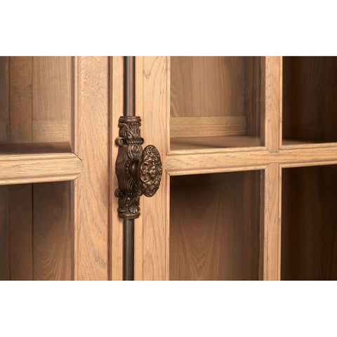 Close-up view of the Lyon Washed Grey Finish Oak Wood Tall Cabinet, highlighting the decorative metal handle and the glass-paneled doors that reveal the interior shelving. The wood has a light, washed grey finish, showcasing the natural grain and texture