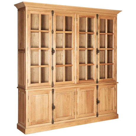 Large cabinet made of natural oak wood featuring a classic design with multiple glass-paneled doors on the top half and solid wood doors on the bottom half. The cabinet has a light wood finish, showcasing the grain of the oak, and is adorned with decorative hardware