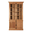 Tall cabinet made of natural oak wood featuring a classic design with two glass-paneled doors at the top and solid wood doors at the bottom. The cabinet has multiple shelves visible through the glass, providing ample storage space. The wood finish showcases the natural grain and texture of the oak