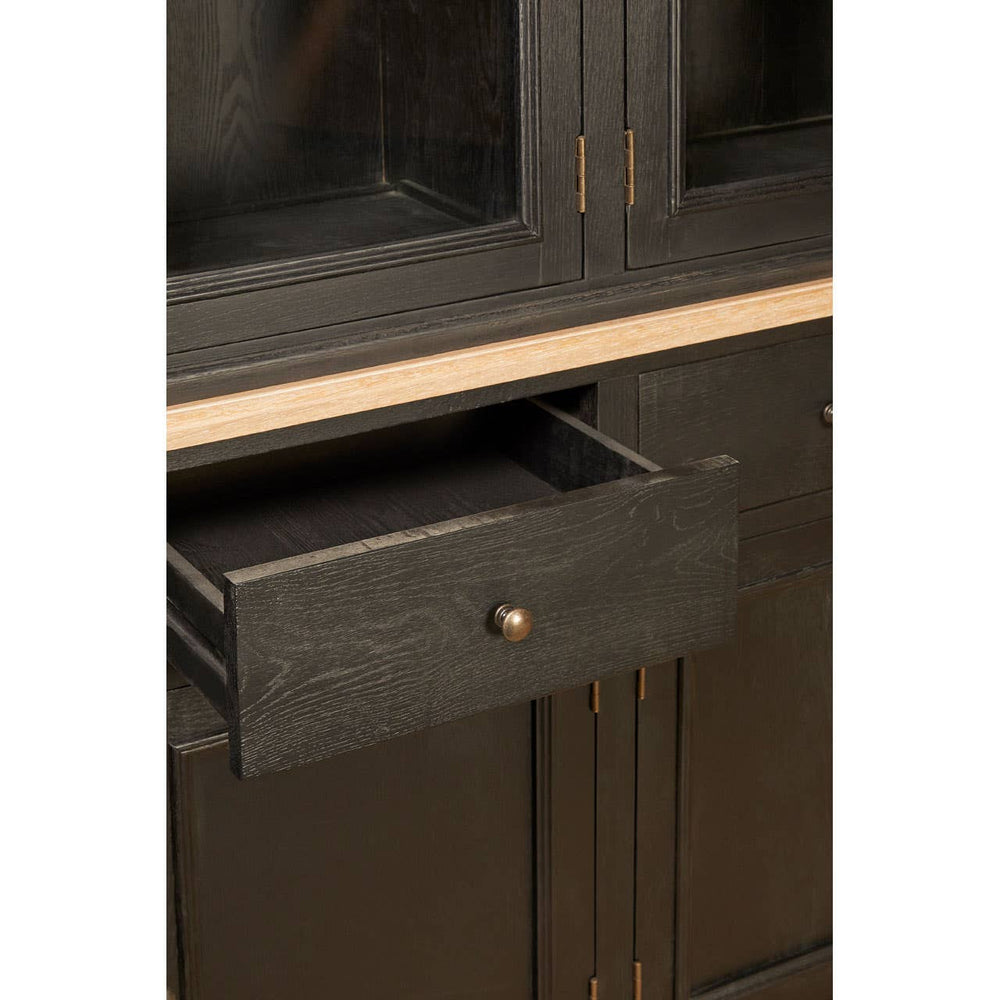 Close-up view of a black oak wood cabinet featuring a single drawer with a round handle, showcasing a sleek design and a smooth finish. The cabinet has a minimalist aesthetic with clean lines and a natural wood grain texture