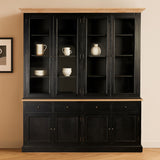Large black oak wood cabinet featuring multiple shelves and glass doors, displaying decorative items such as vases and dishes. The cabinet has a smooth top surface and a lower section with closed storage, set against a neutral wall with a framed picture nearby