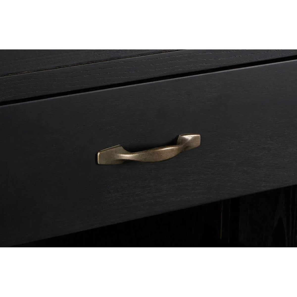 Black wooden drawer with bronze metal handle, close-up of furniture detail