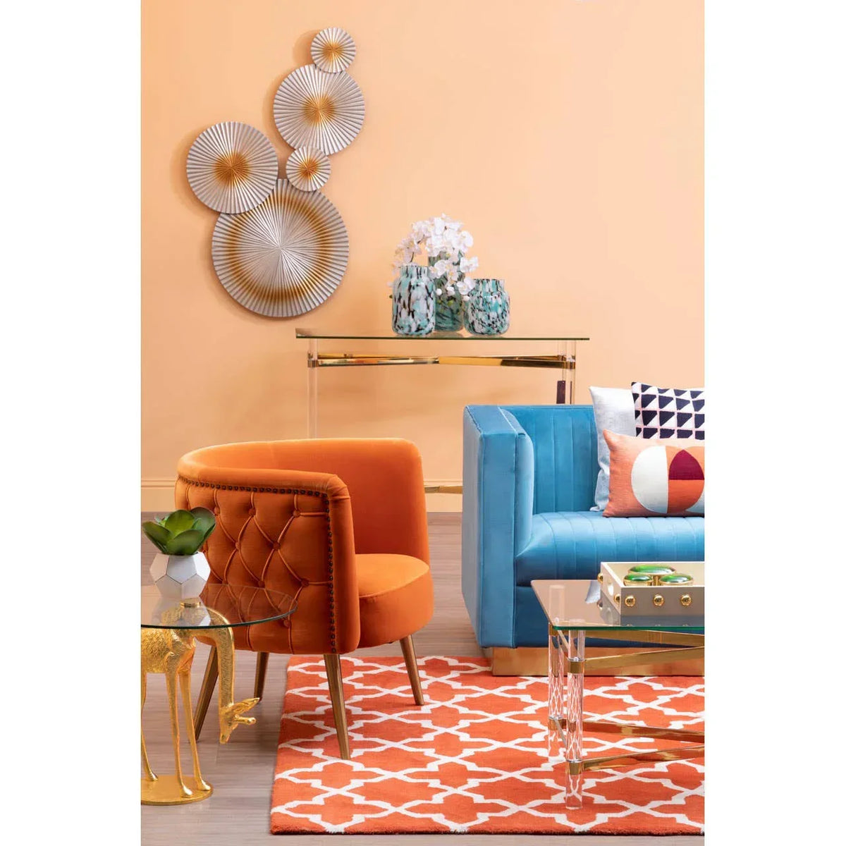 Velvet orange accent chair and blue sofa with patterned cushions in modern living room