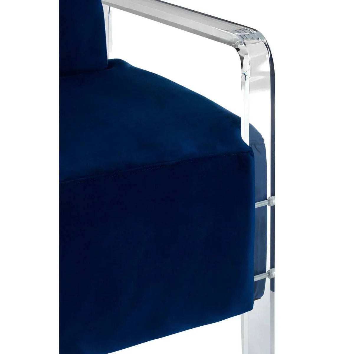 Velvet armchair in deep blue with clear acrylic armrest, close side view