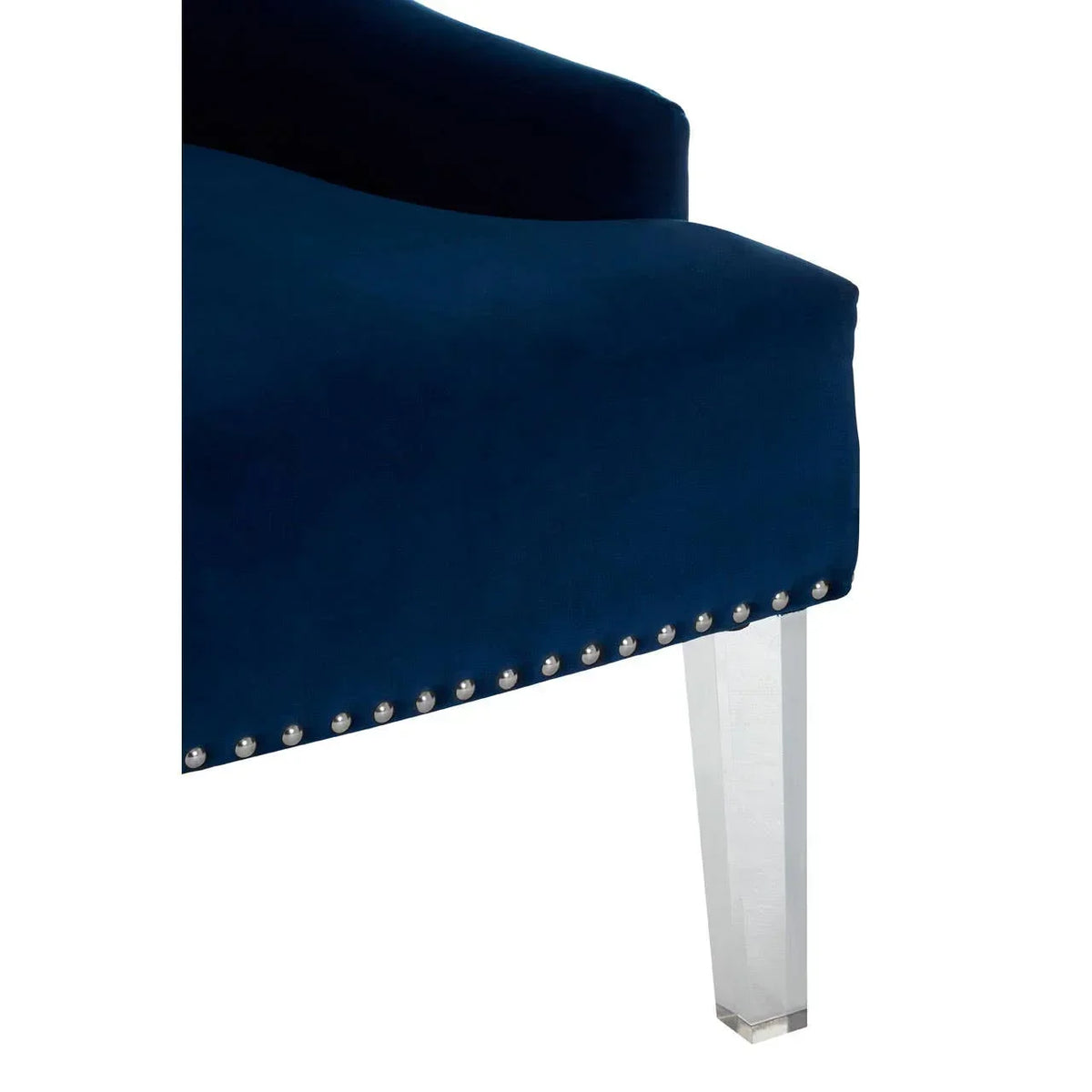 Navy blue velvet chair corner with silver stud detailing and clear acrylic leg
