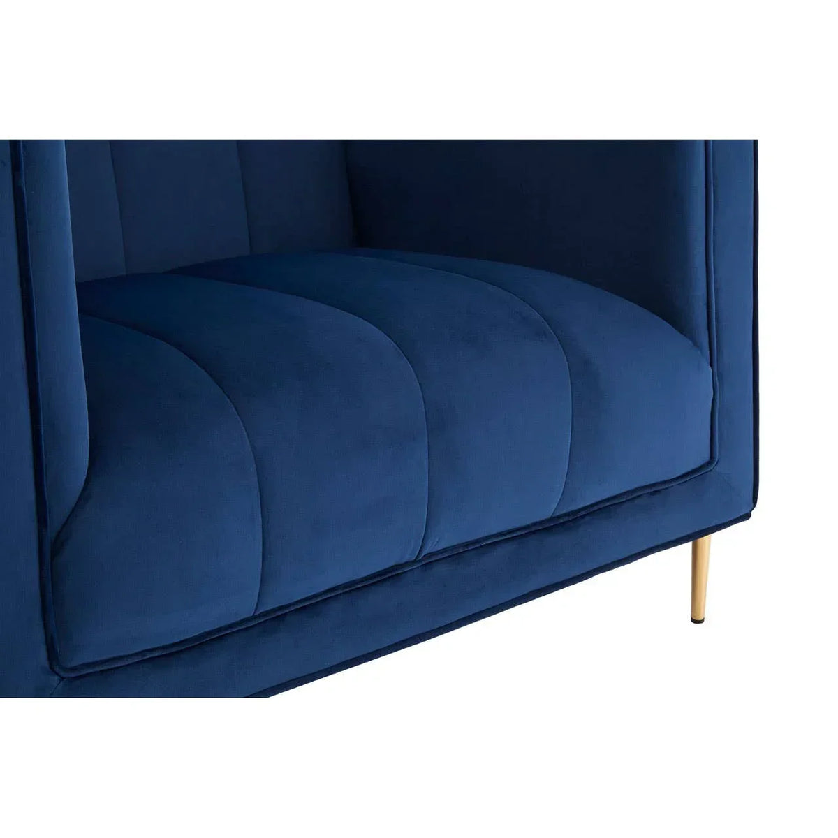Blue velvet sofa seat with vertical stitching and gold metal leg close-up