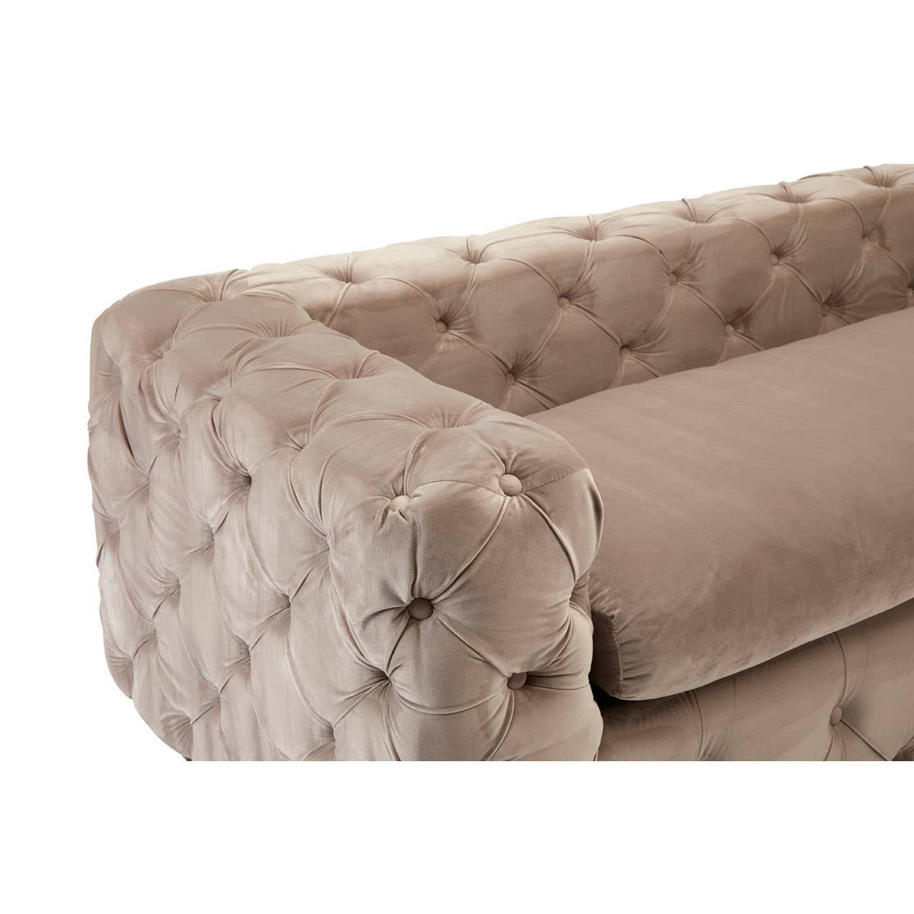 Beige velvet sofa with a tufted design, featuring a low backrest and plush cushions, showcasing a rounded armrest with button detailing