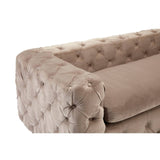 Beige velvet sofa with a tufted design, featuring a low backrest and plush cushions, showcasing a rounded armrest with button detailing