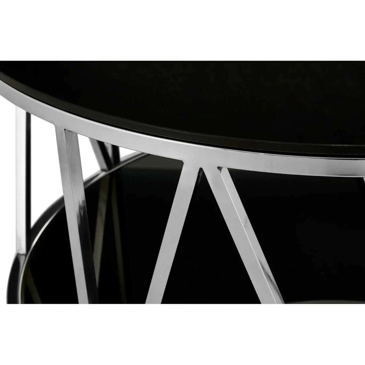 Closeup of round black glass coffee table with chrome metal legs