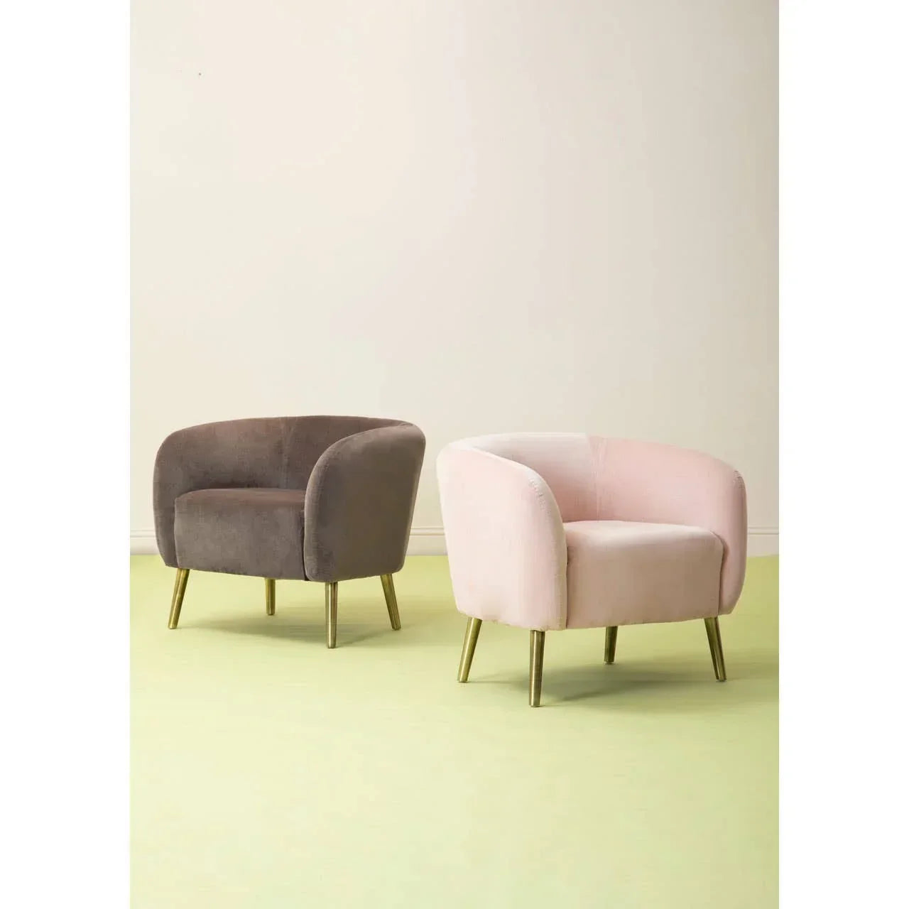 Velvet accent armchairs in blush pink and taupe with gold legs on pale flooring