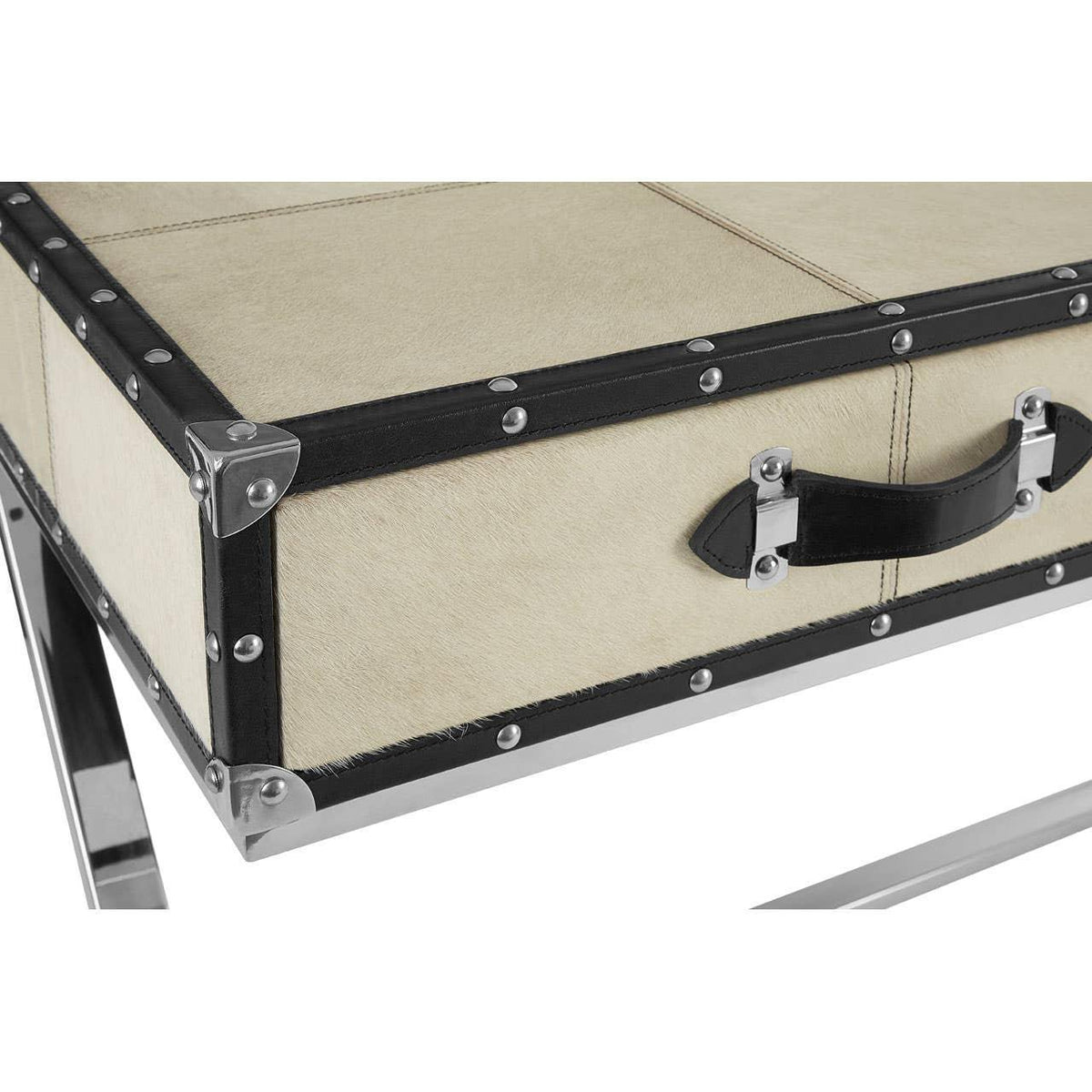 Close-up of cream and black studded desk with metal legs and handle