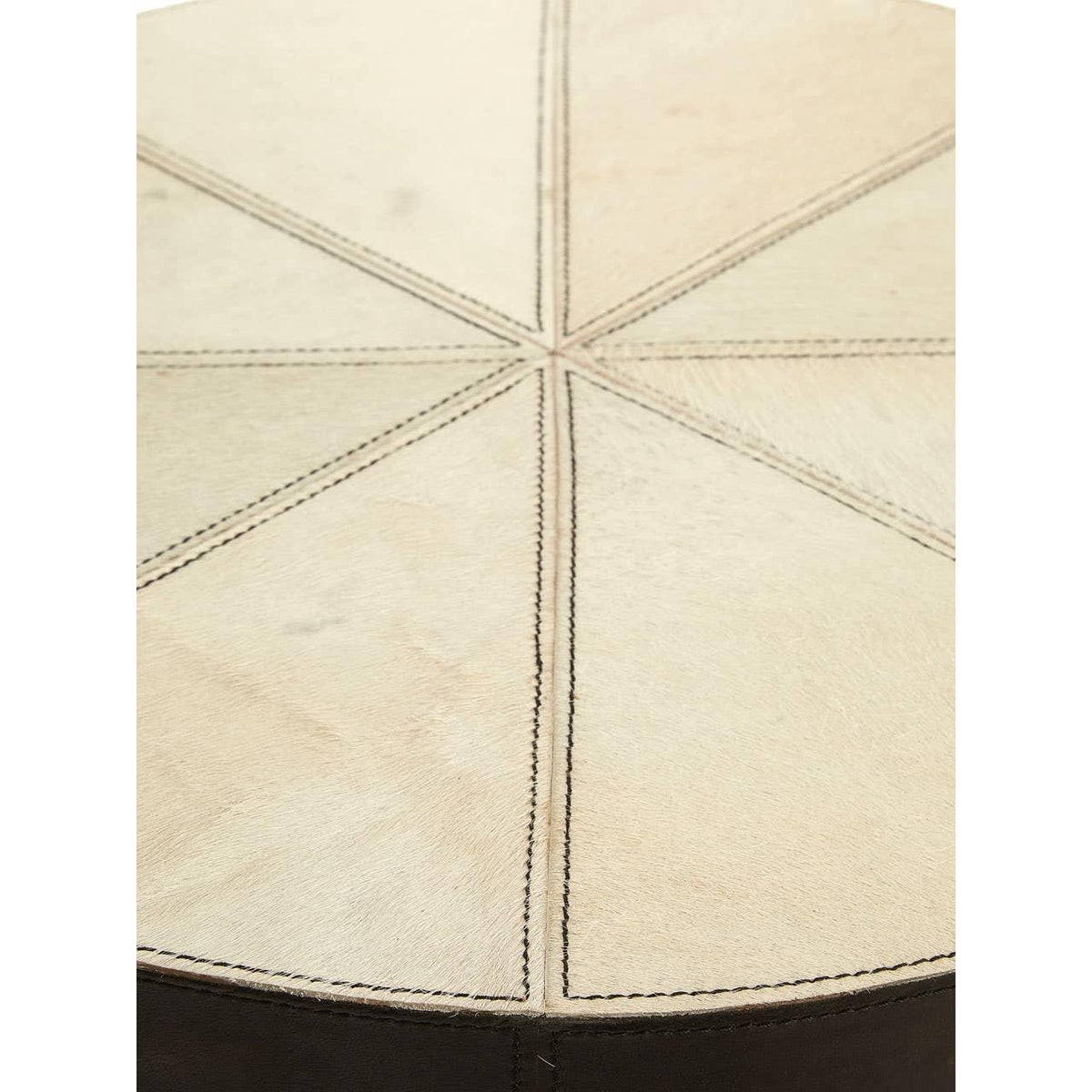 Round cream cowhide pouffe top with stitched panel detail and dark leather side