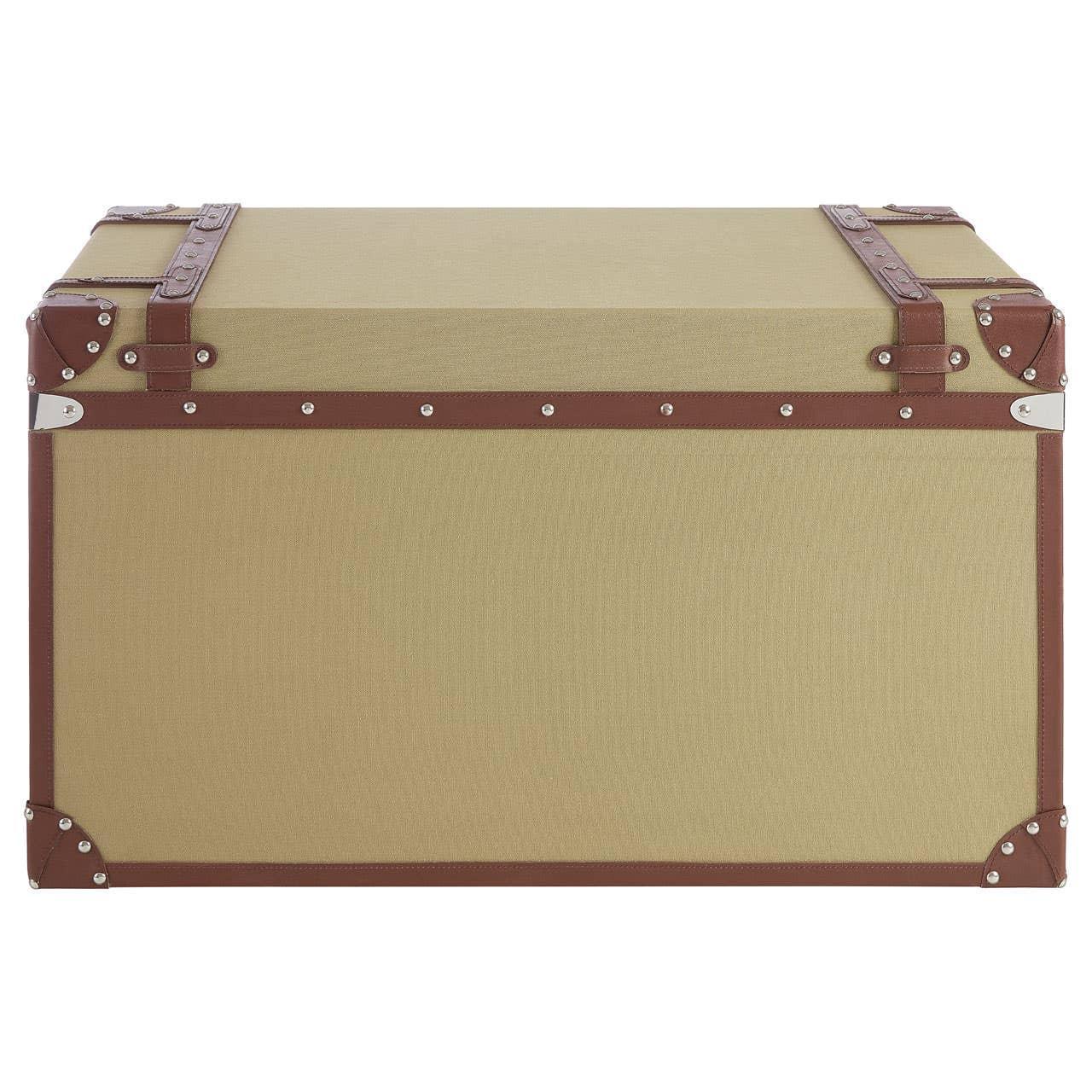 Beige storage trunk with brown faux leather trim and metal corner accents, front view
