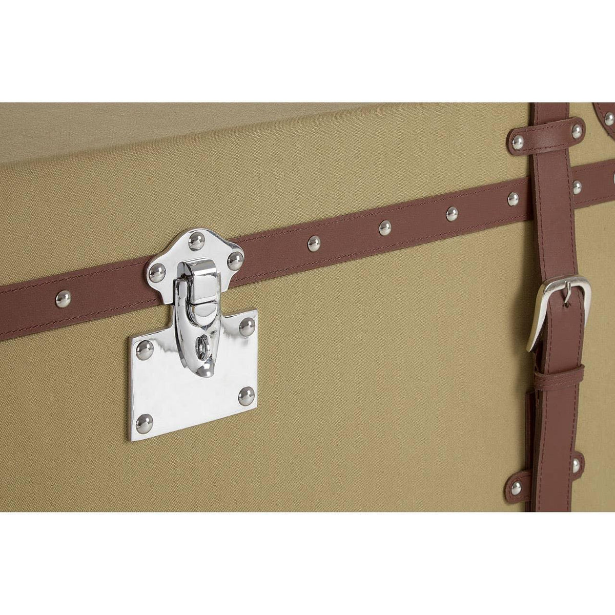 Beige storage trunk with brown leather trim and silver hardware detail close-up
