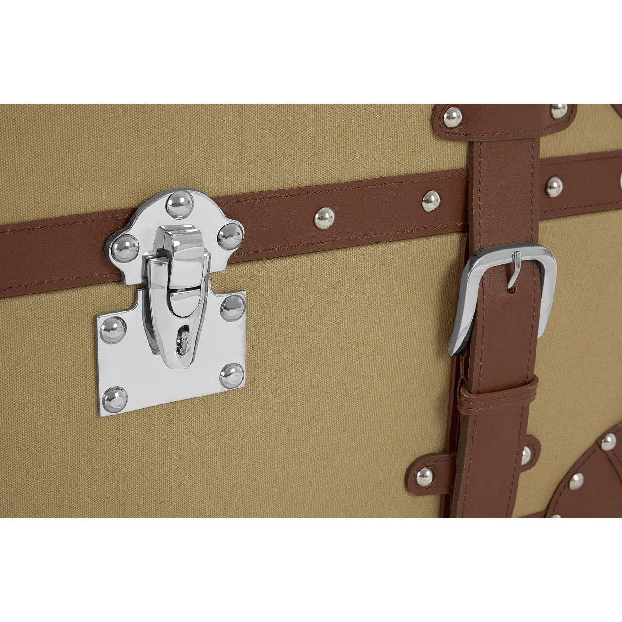Close-up of storage trunk with brown faux leather strap and silver buckle detail