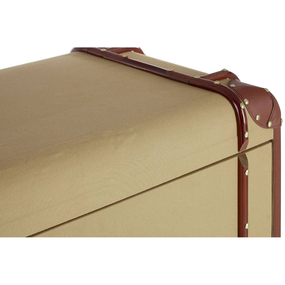 The Columbus Trunk Style Chest features a sleek, rectangular design with a smooth, golden surface and brown leather accents. The corners are reinforced with metal studs, and there are two drawers visible at the front, each with a simple handle. The overall aesthetic combines vintage charm with modern functionality